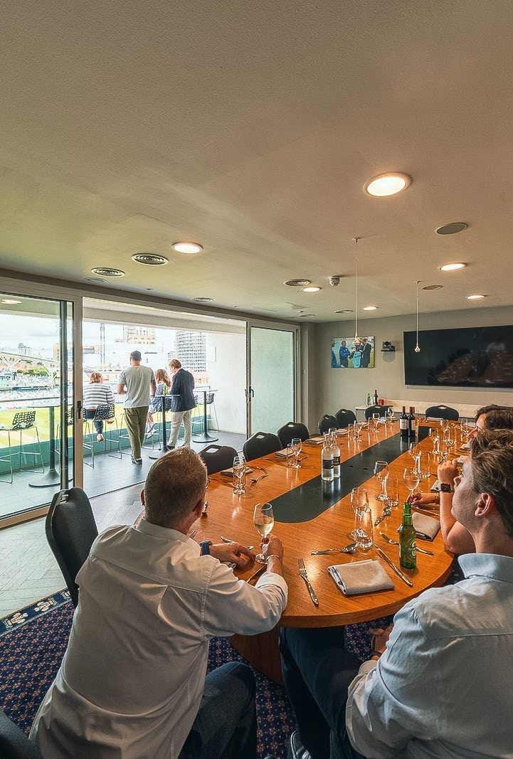 Guests dining at the long table in the Boardroom at The Kia Oval
